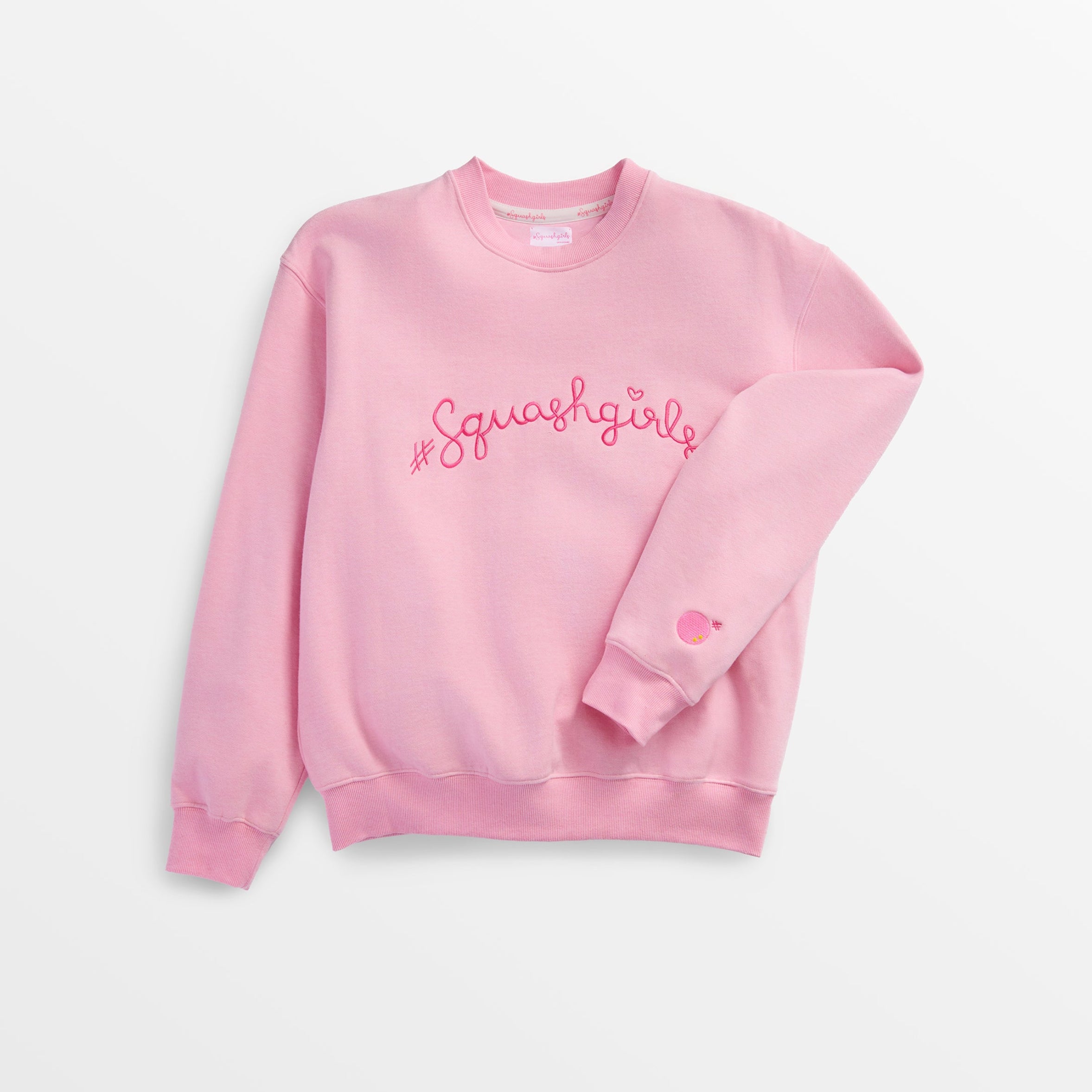 Pink sweatshirt with 'Squash Girl' text on a light gray background