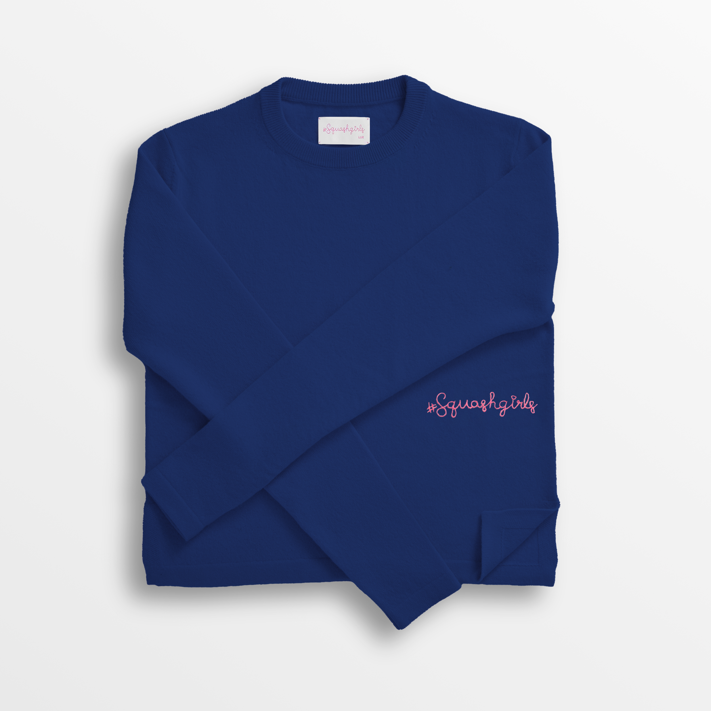 Blue cashmere sweater with pink text on a white background