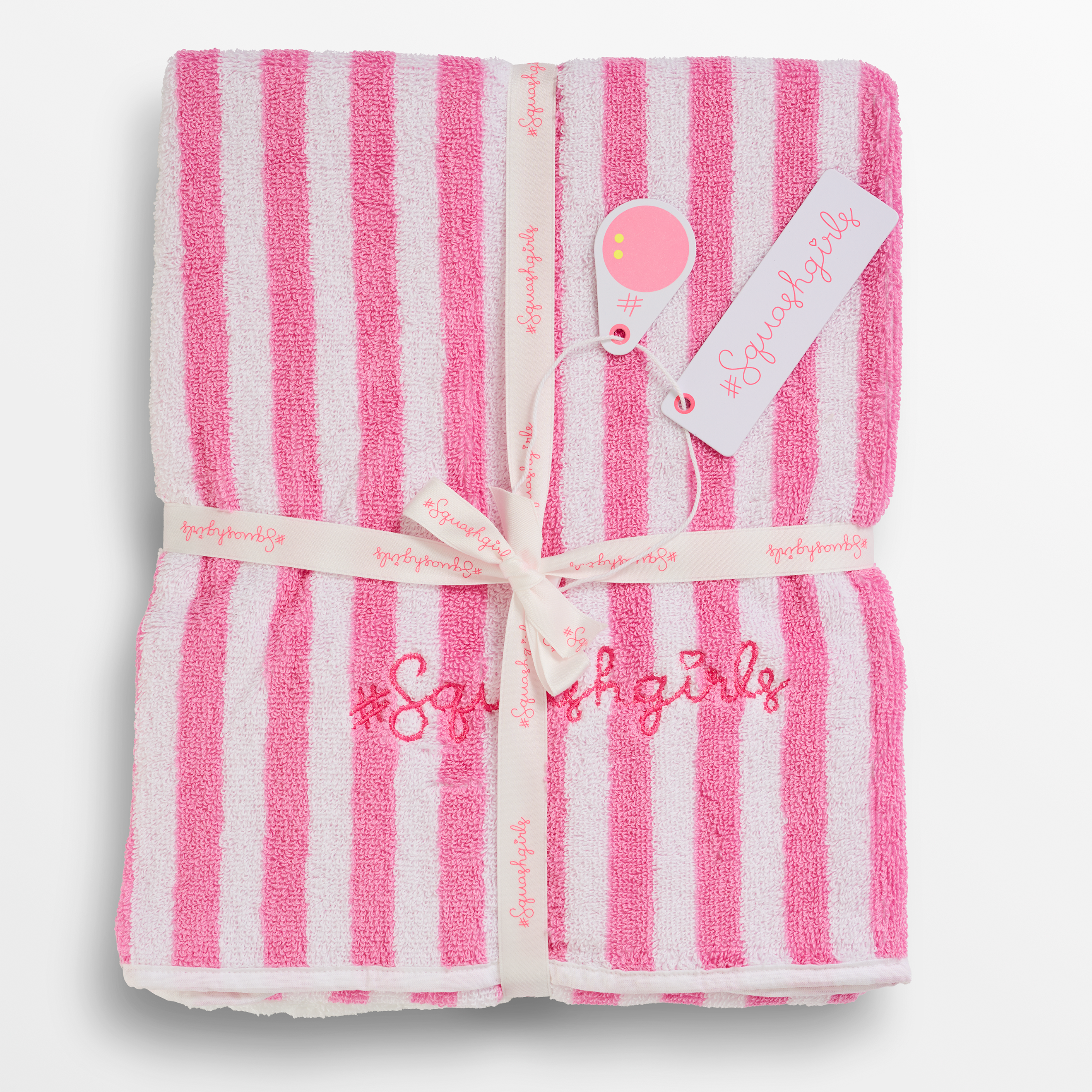 Pink and white striped towel with embroidered text on a light gray background