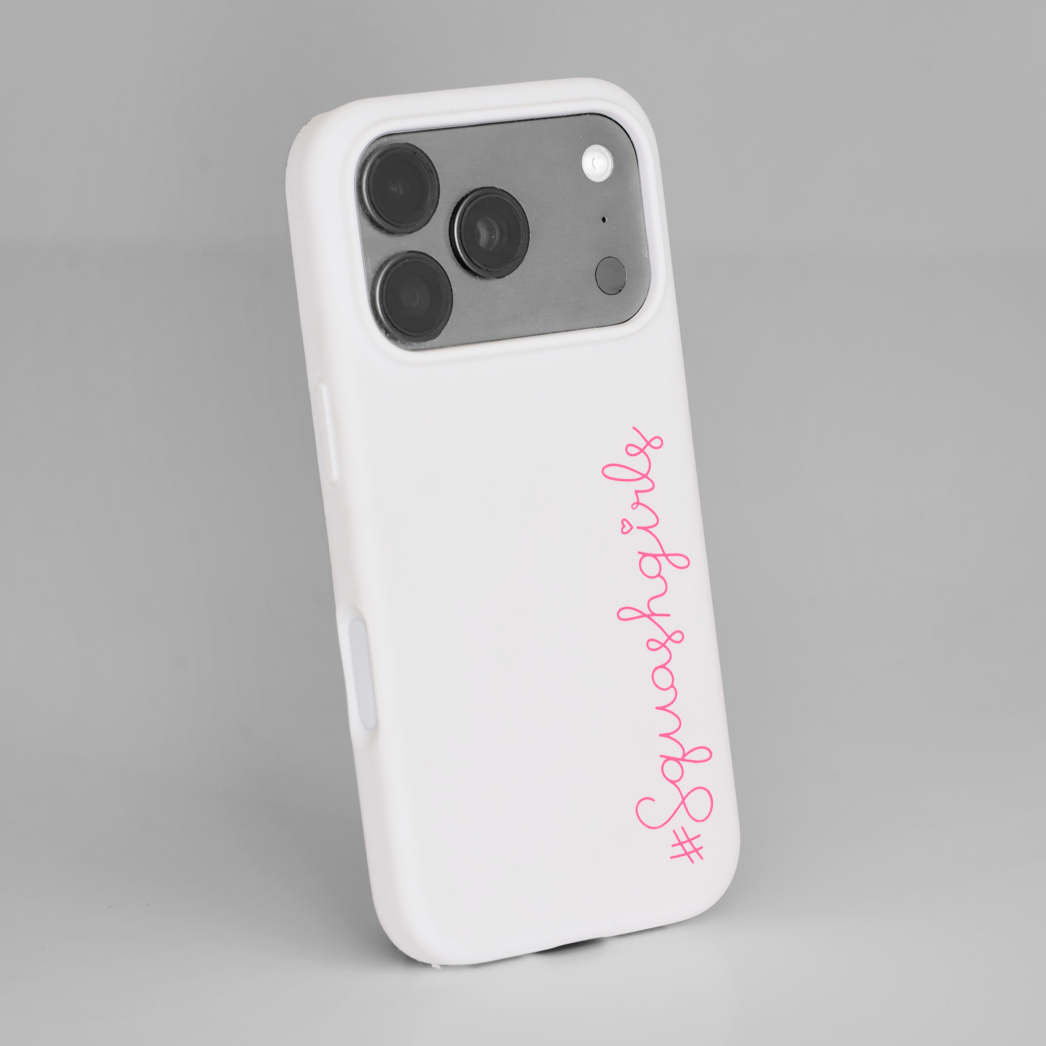 White phone case with pink text on a gray background