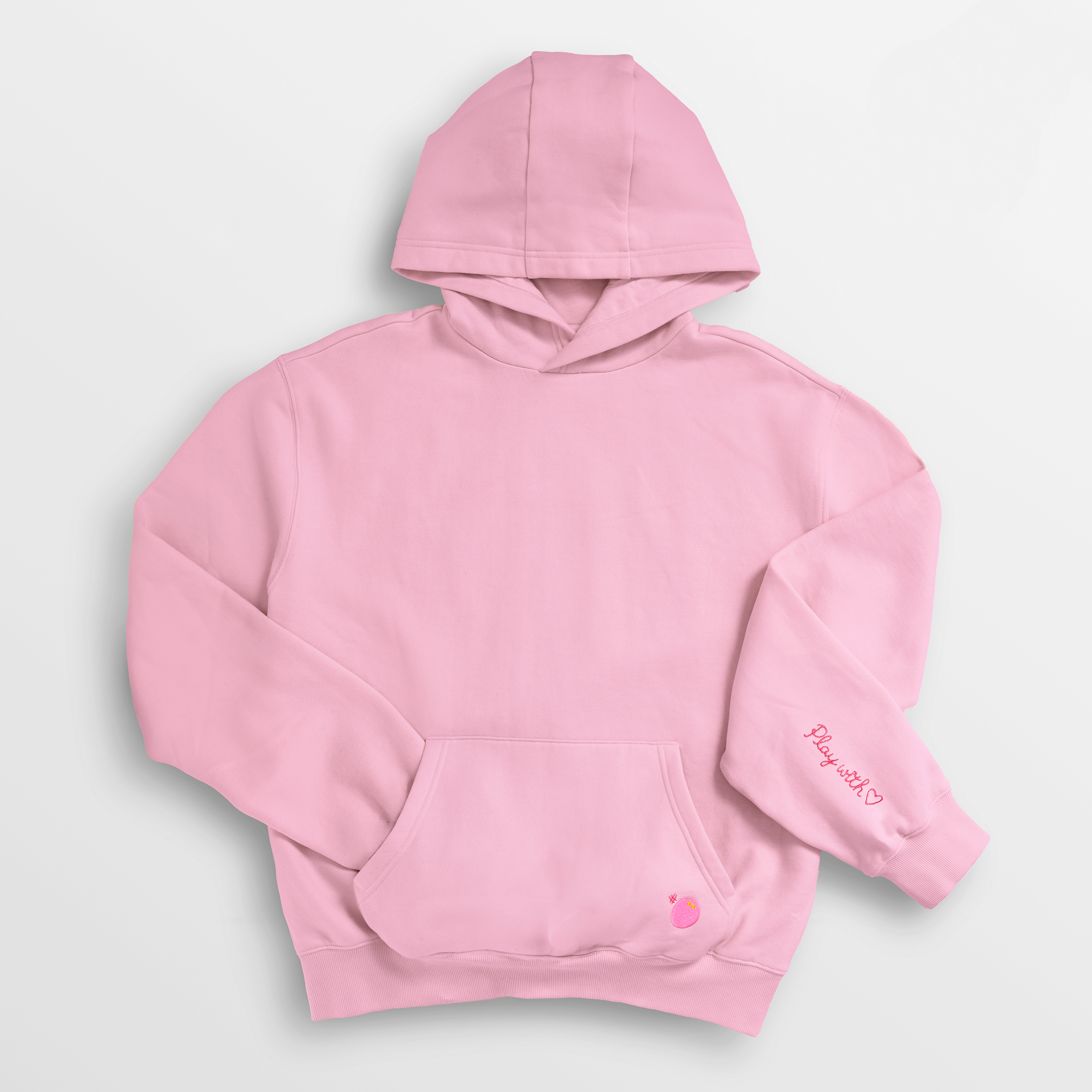 Pink hoodie with text on sleeve against a light gray background