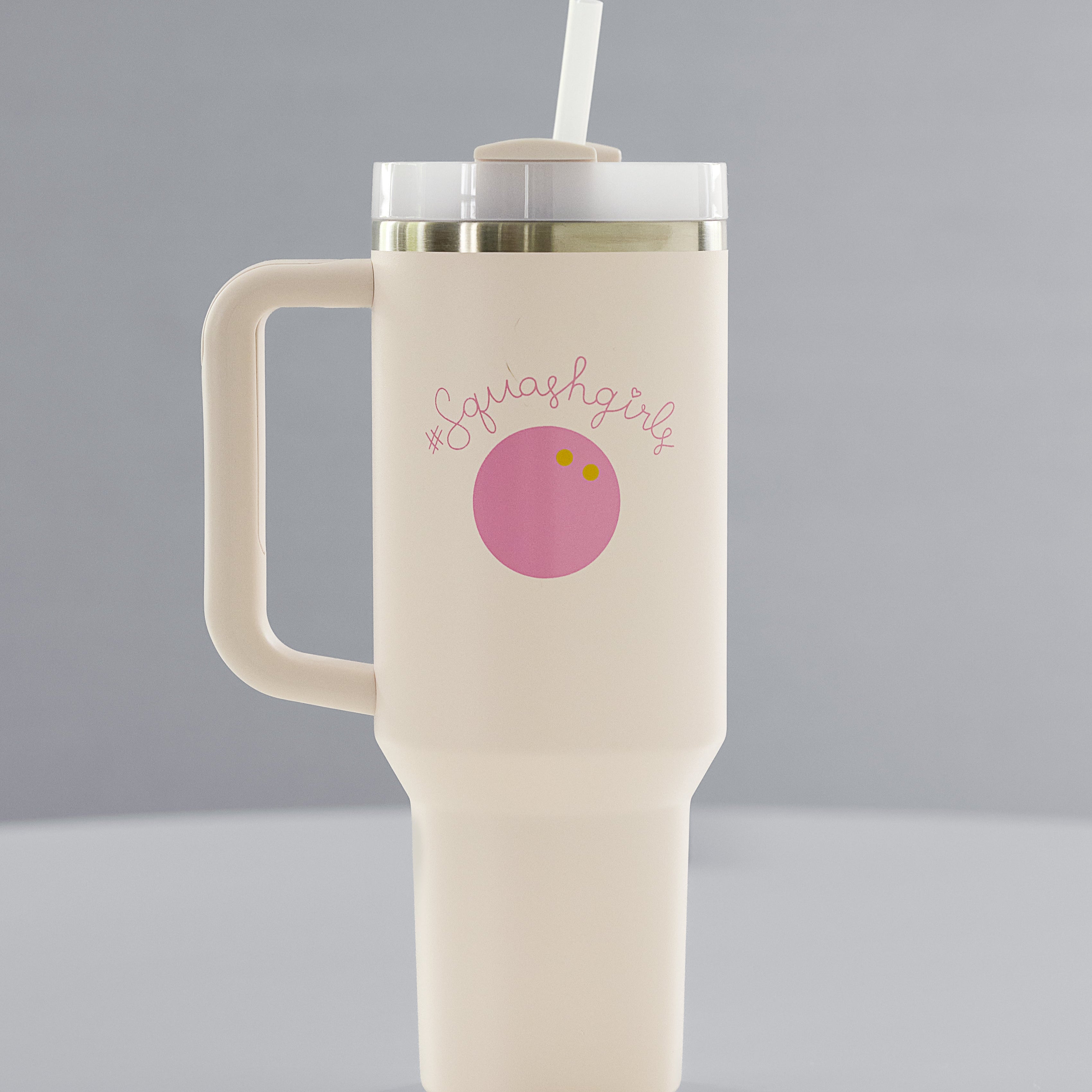 Beige mug with handle and straw lid on a gray background