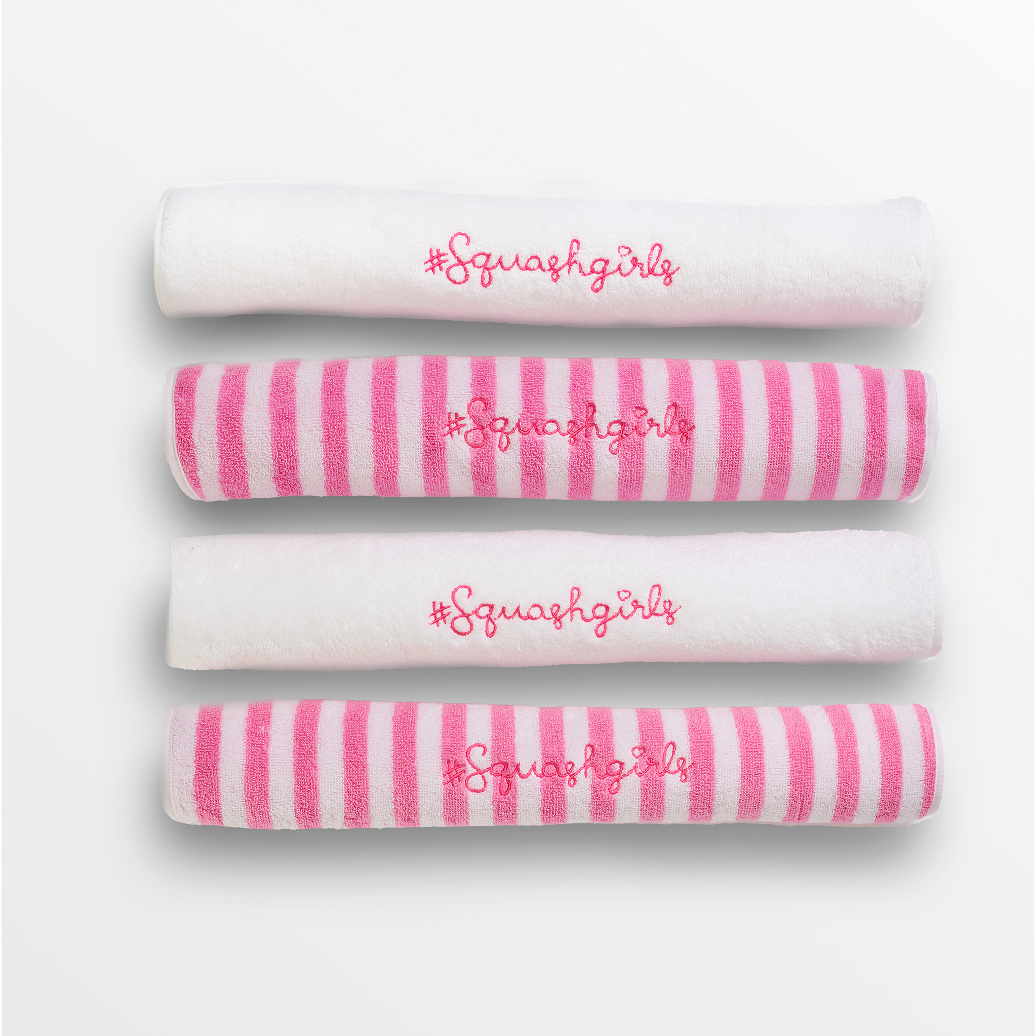 Set of four towels with pink stripes and 'Squashgirls' text on a white background
