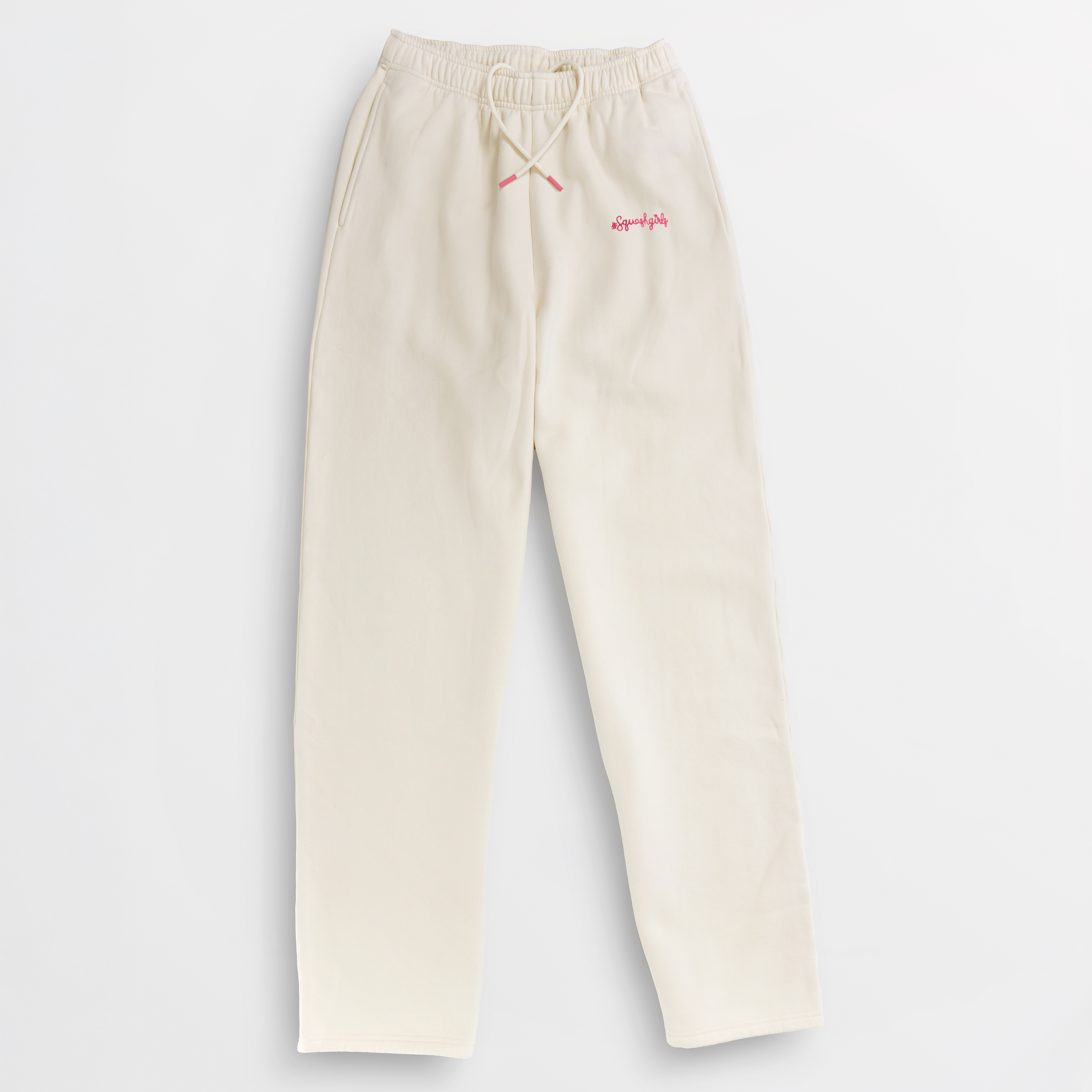 Beige sweatpants with a logo on a light gray background